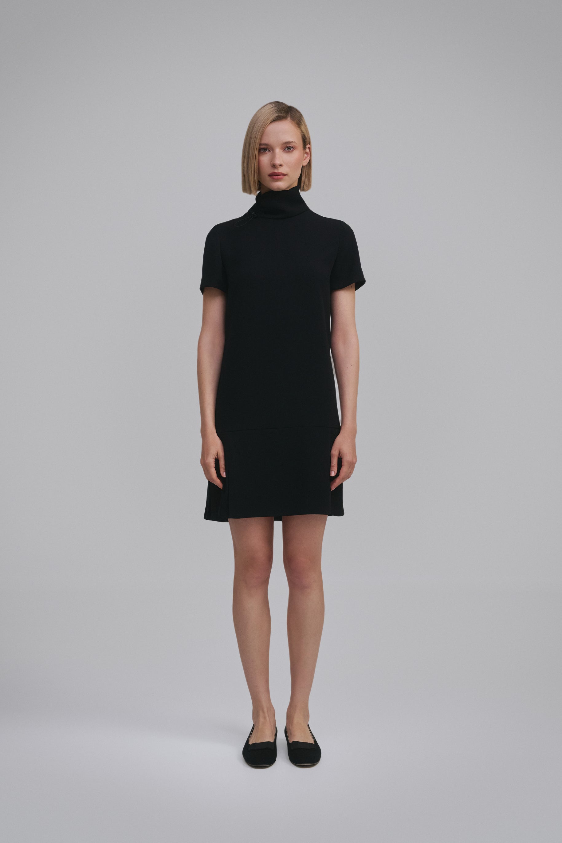 Model wears the Amelia Toro Short-Sleeve Pleated Chiffon Mini Dress in Black, front view