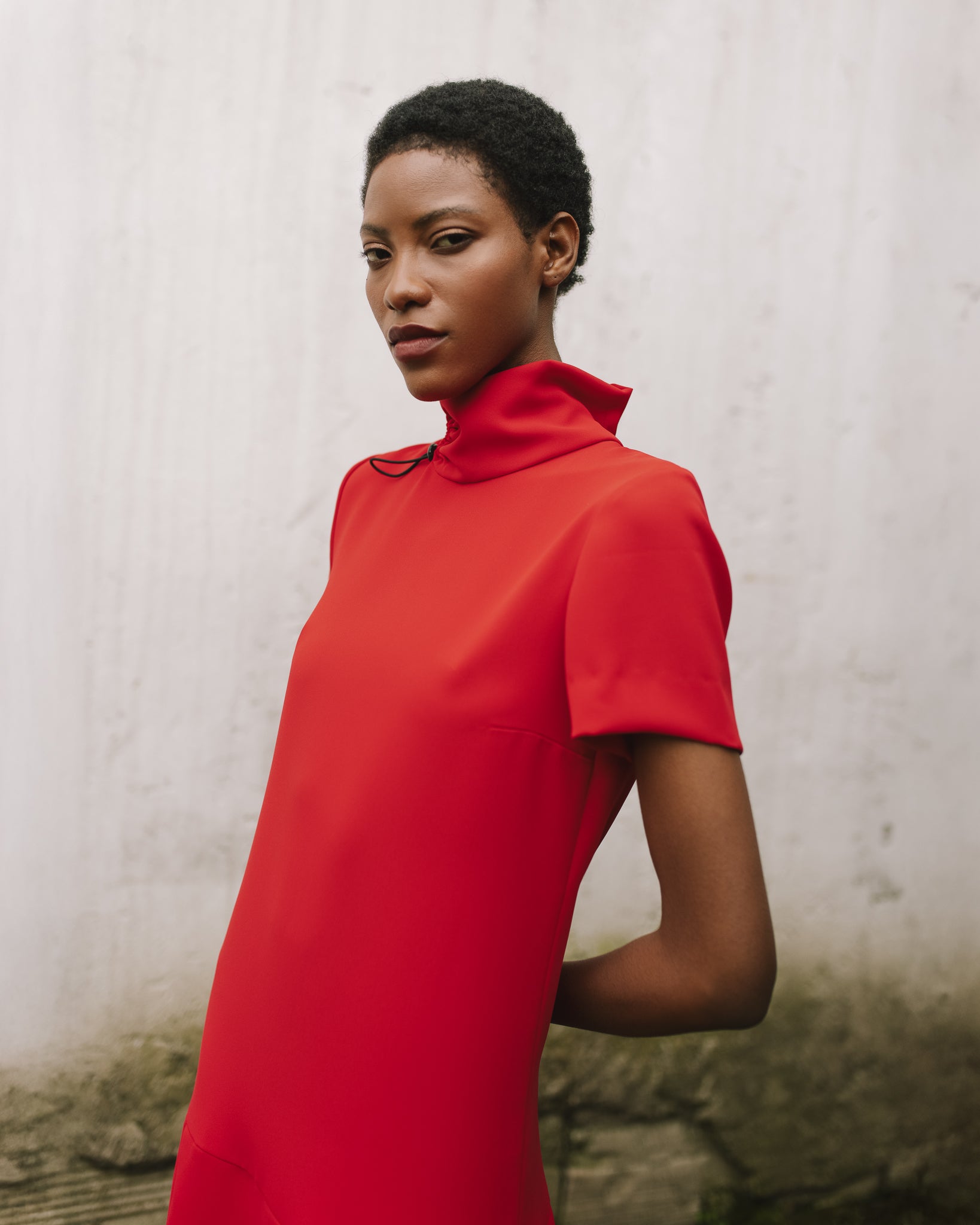 Model wears the Amelia Toro Short-Sleeve Pleated Chiffon Mini Dress in Black, front view