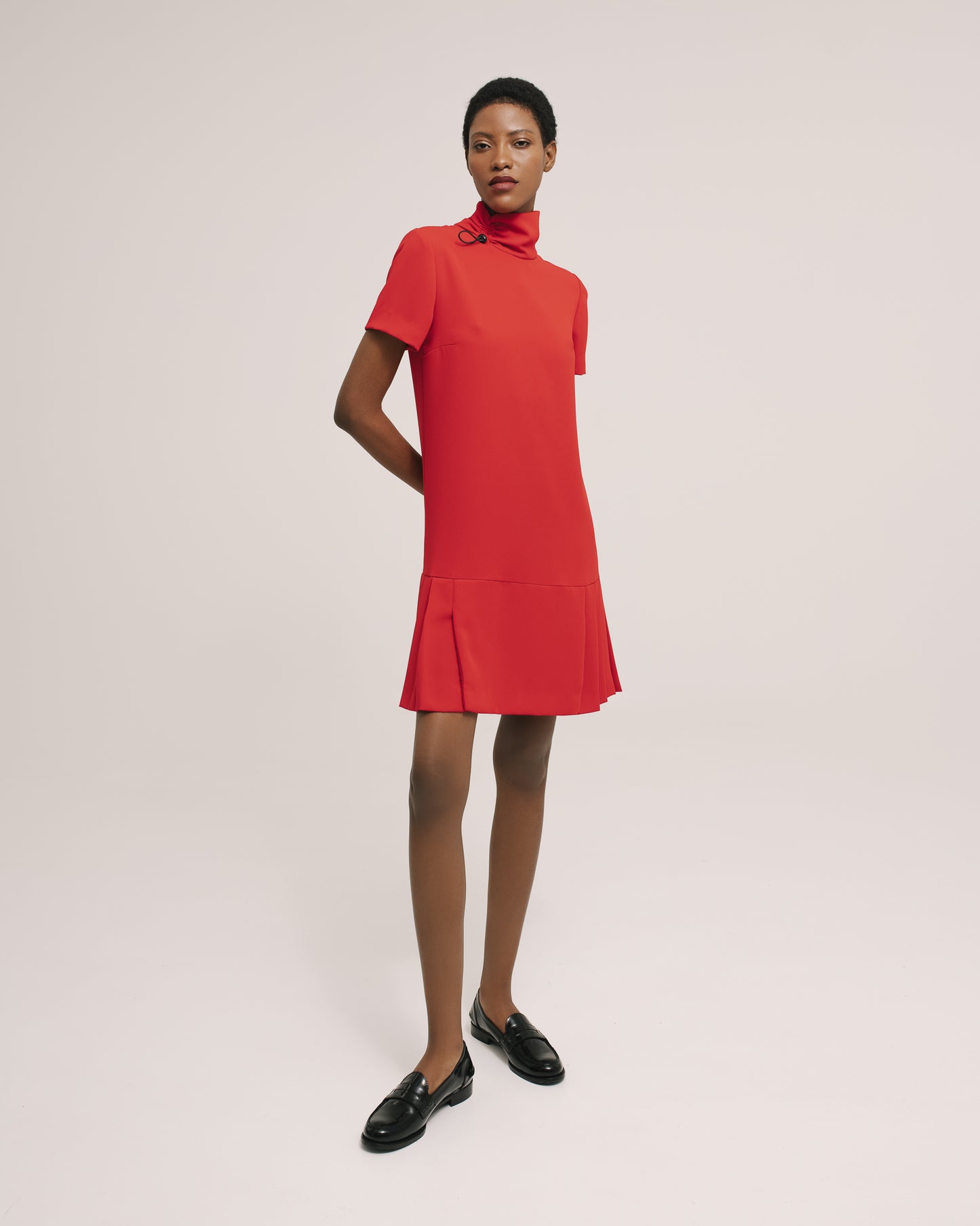 Model wears the Amelia Toro Short-Sleeve Pleated Chiffon Mini Dress in Black, front view