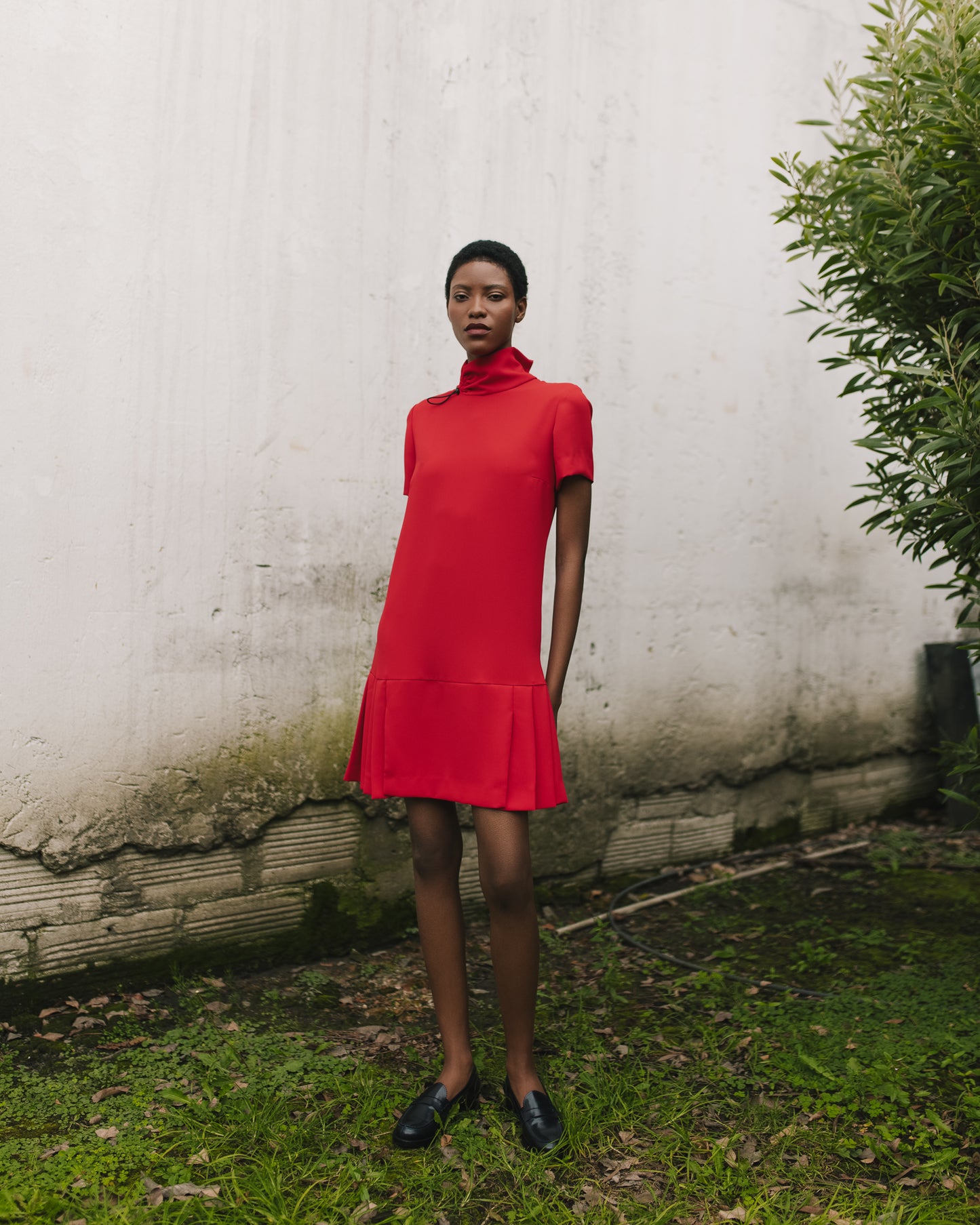 Model wears the Amelia Toro Short-Sleeve Pleated Chiffon Mini Dress in Red, front view
