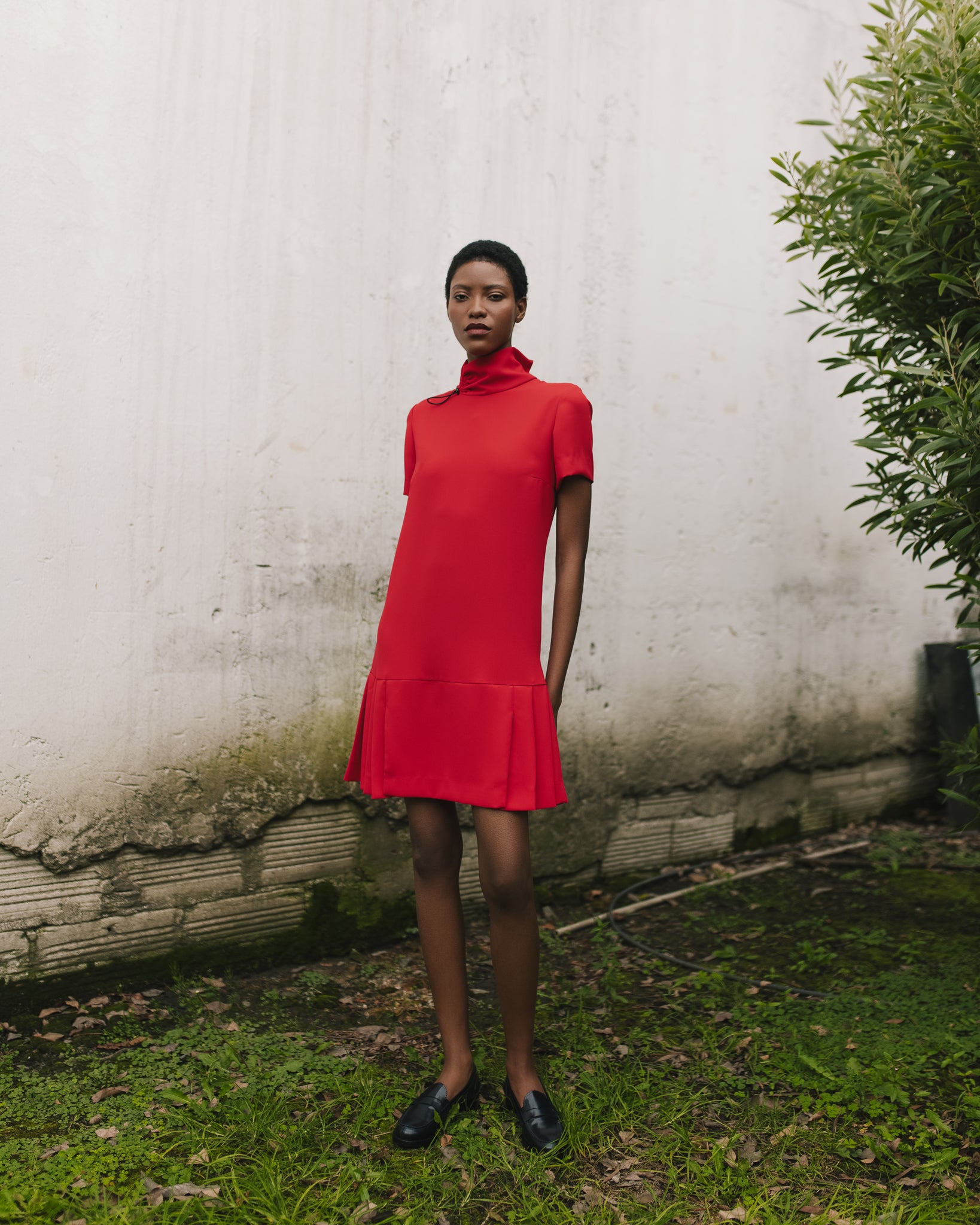 Model wears the Amelia Toro Short-Sleeve Pleated Chiffon Mini Dress in Red, front view
