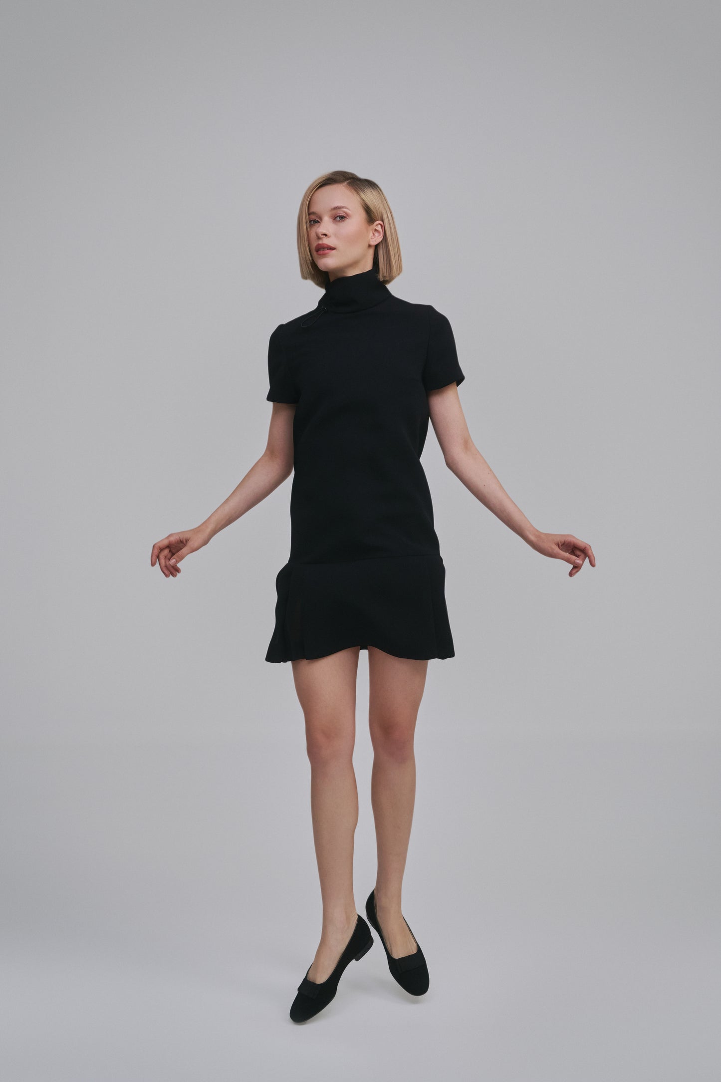 Model wears the Amelia Toro Short-Sleeve Pleated Chiffon Mini Dress in Red, front view