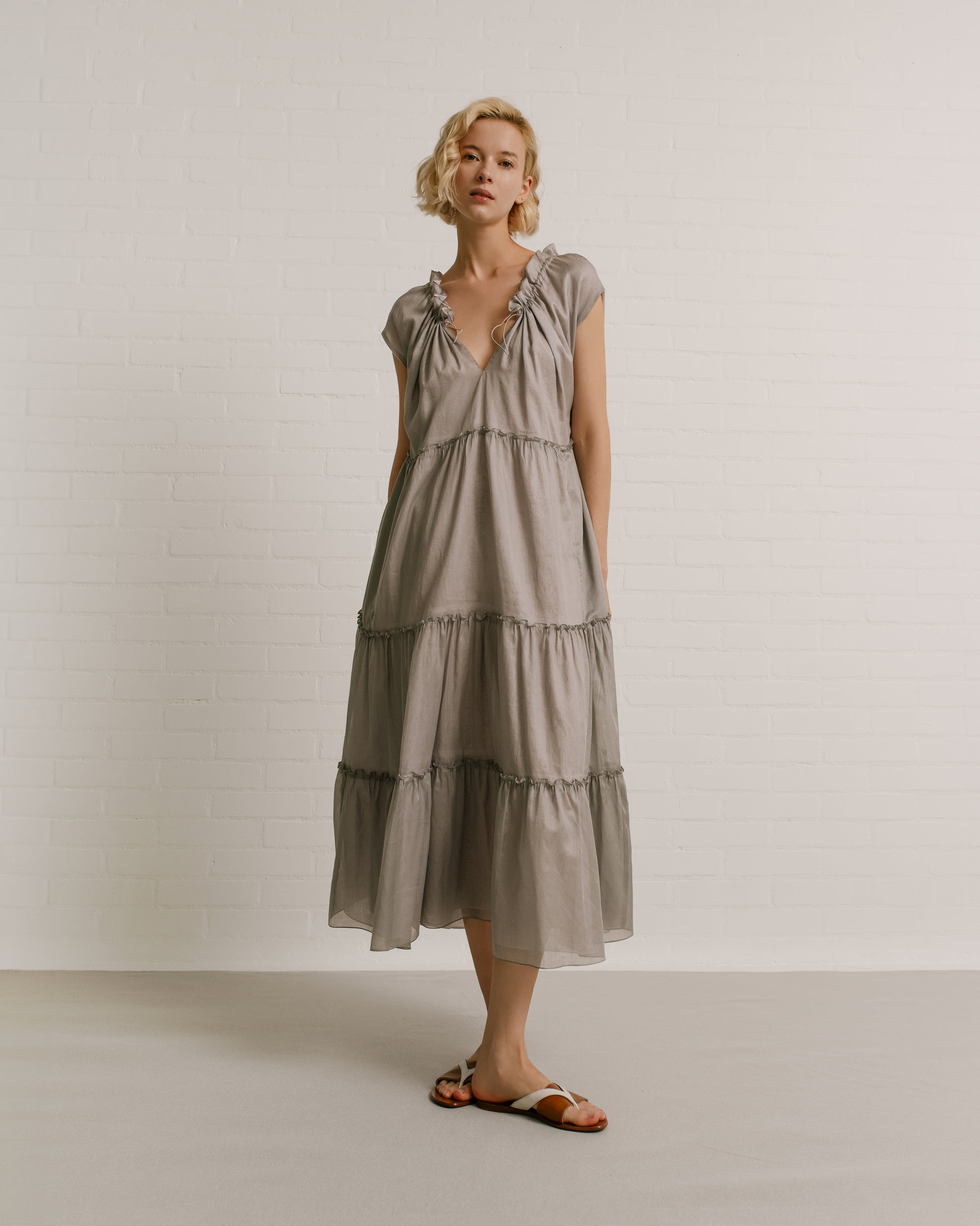 Model wears the Amelia Toro Sleeveless Ruffled Cotton Voile Midi Dress in Grey/Pink, front view
