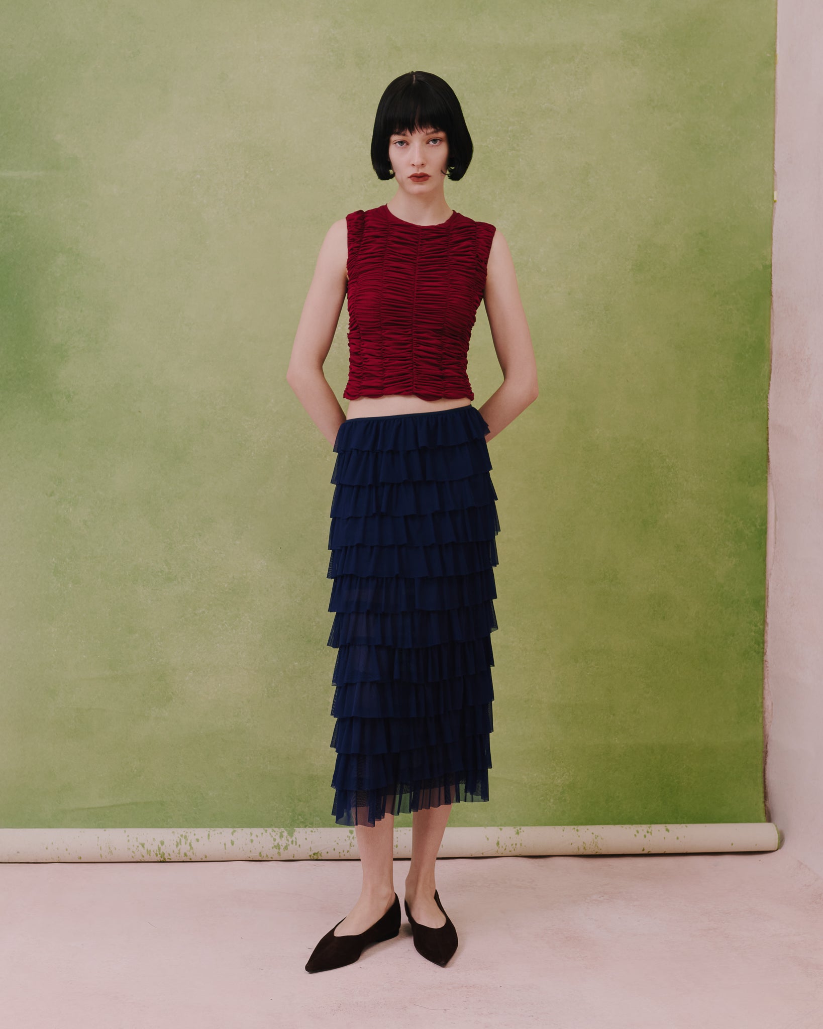 Model wears the Amelia Toro Tiered Ruffle Tulle Maxi Skirt in blue, front view