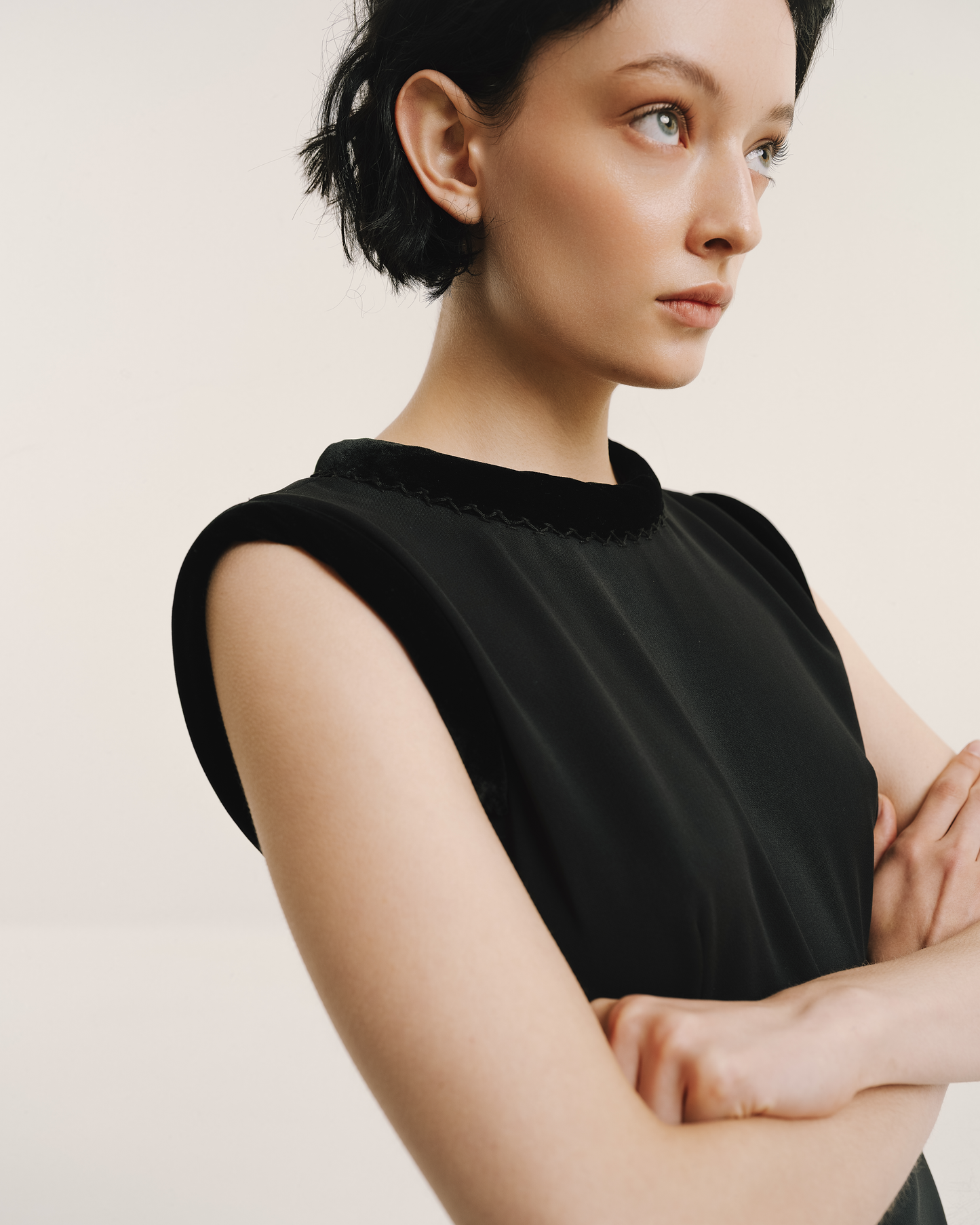 Model wears the Amelia Toro Velvet-Trimmed Black Midi Dress in black, front view