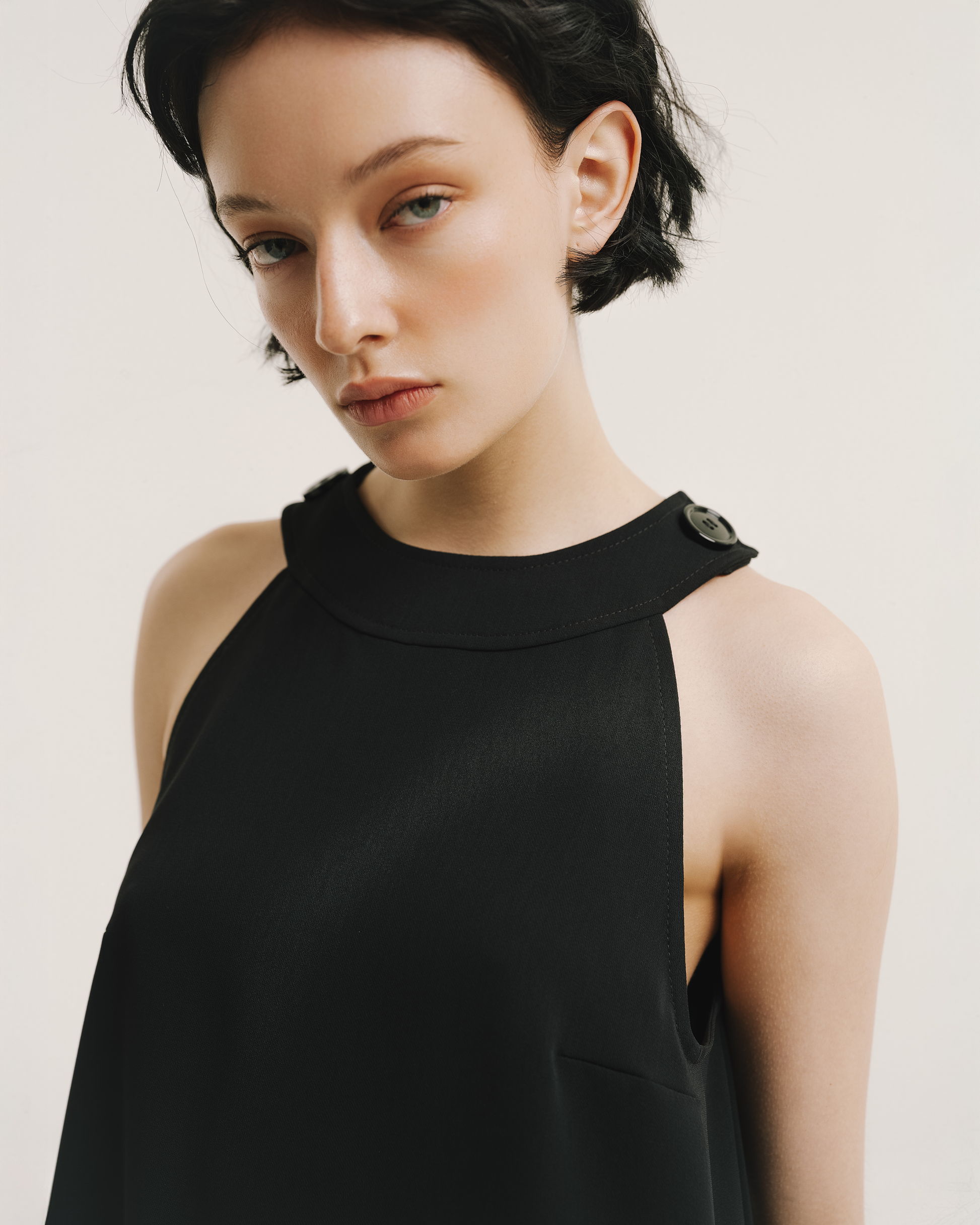 Model wears the Amelia Toro Velvet-Trimmed Little Black Jumper in black, front view