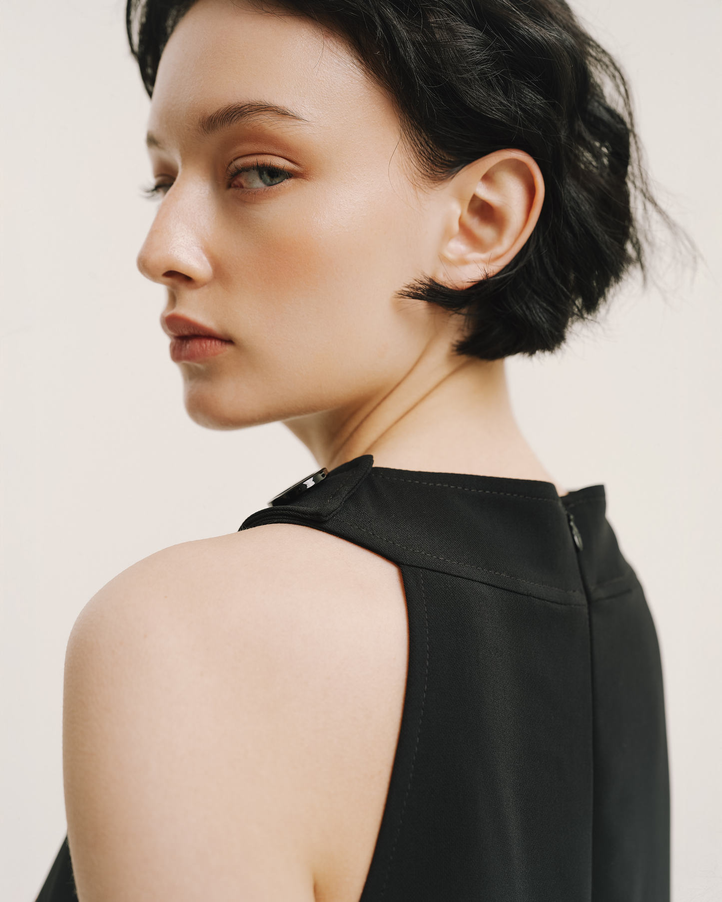 Model wears the Amelia Toro Velvet-Trimmed Little Black Jumper in black, front view