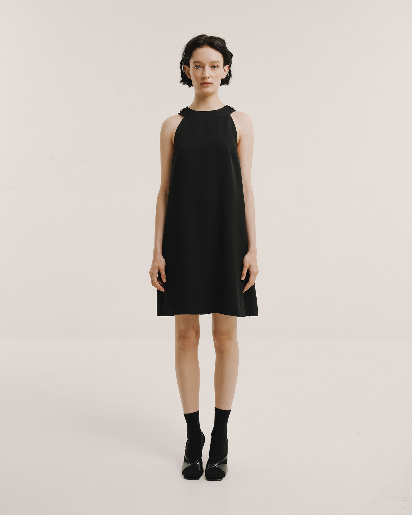 Model wears the Amelia Toro Velvet-Trimmed Little Black Jumper in black, front view