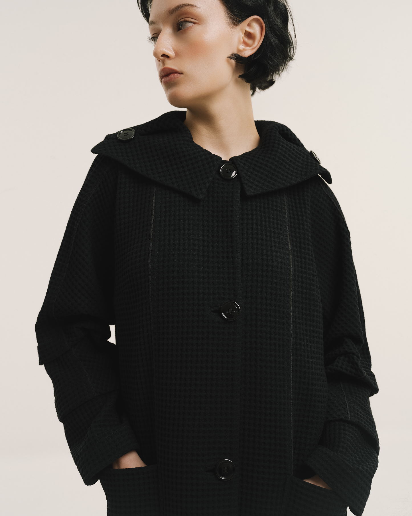 Model wears the Amelia Toro Waffle Lightweight Wool Sailor Coat in black, front view