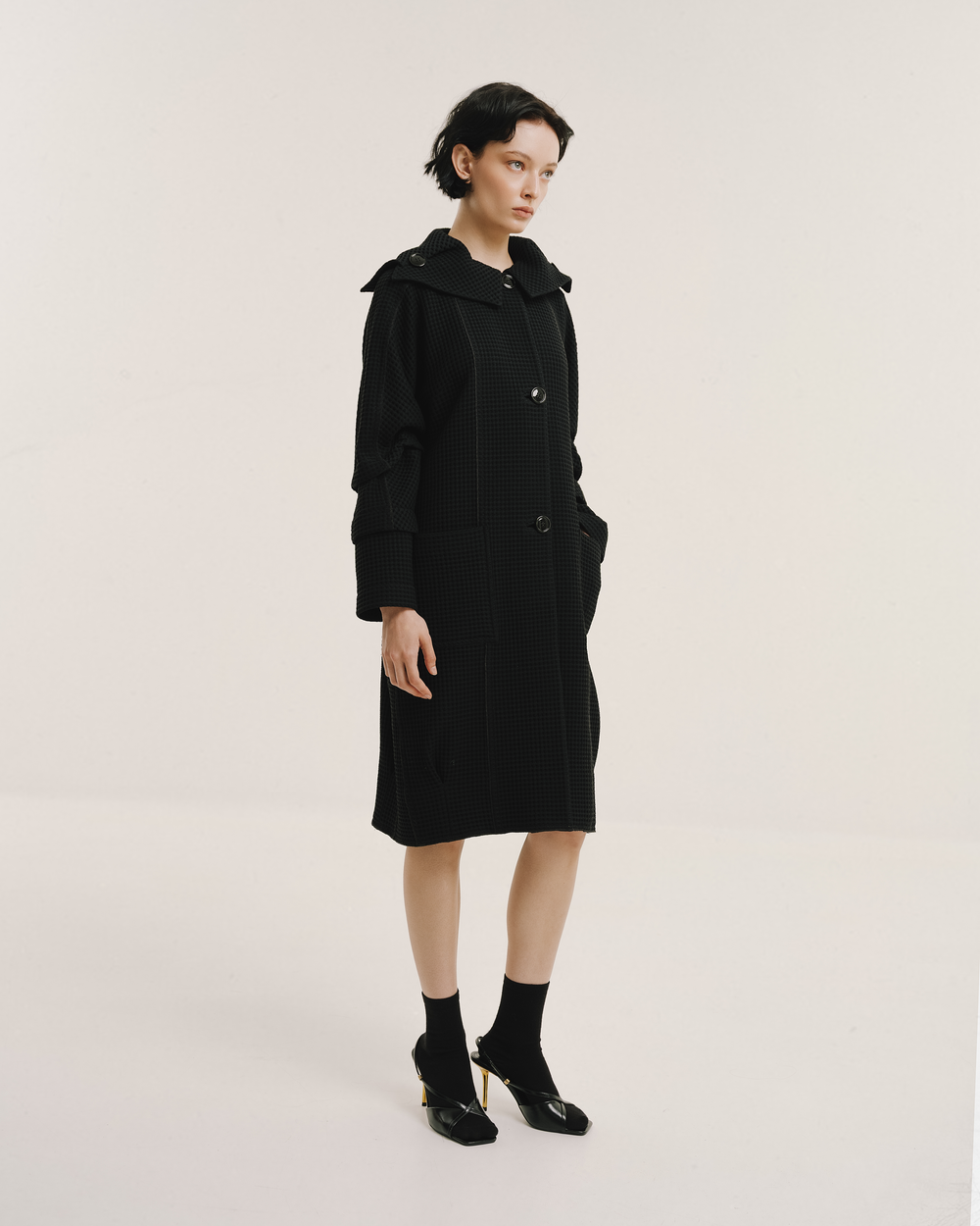 Model wears the Amelia Toro Waffle Lightweight Wool Sailor Coat in black, front view