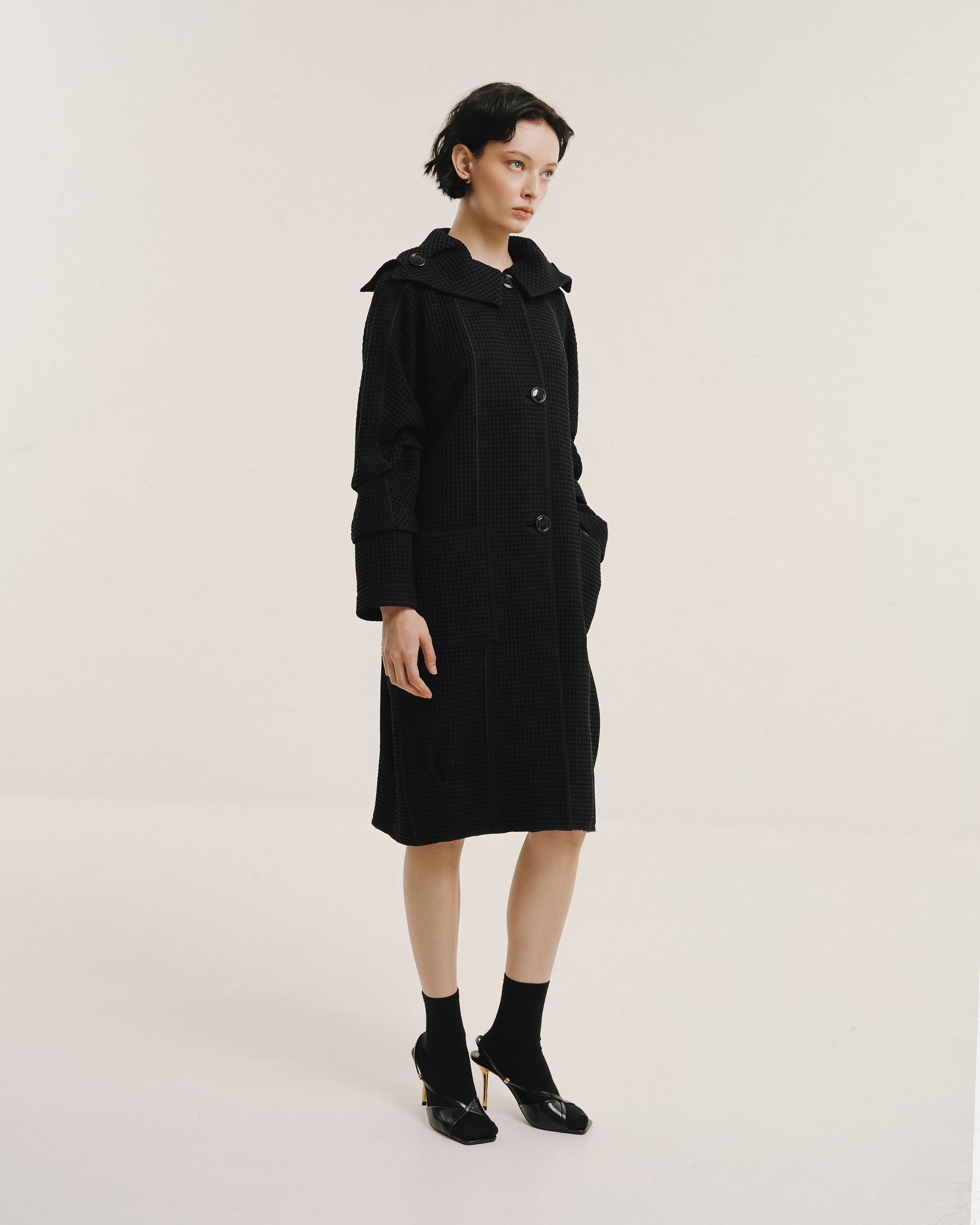 Model wears the Amelia Toro Waffle Lightweight Wool Sailor Coat in black, front view