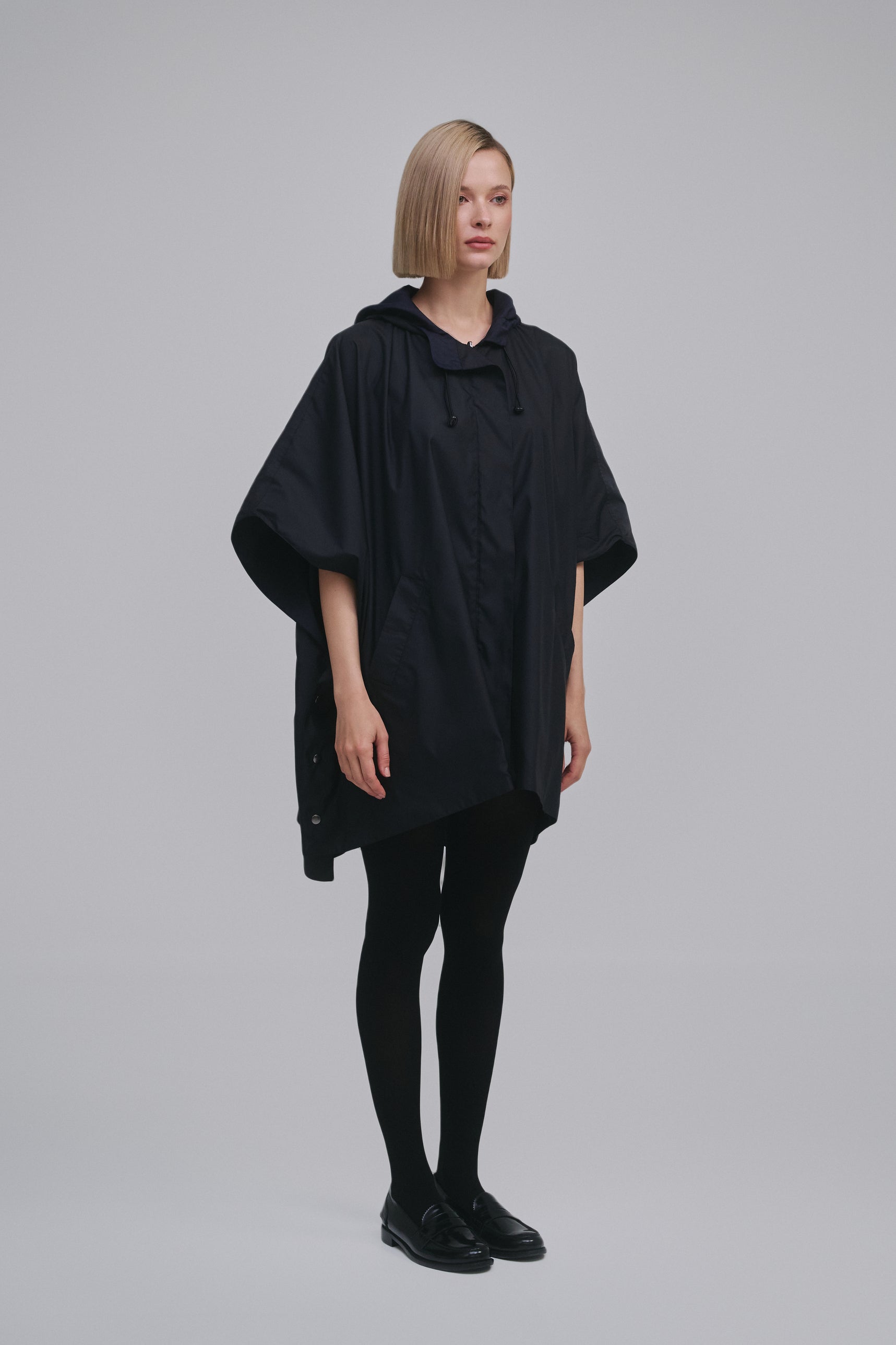Side view of the Amelia Toro Water-Repellent Hooded Poncho in Black